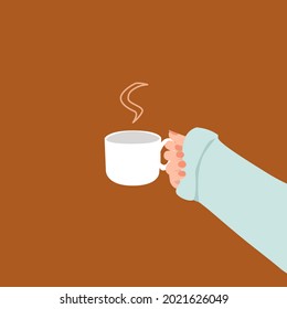 Woman's hand holding a cup of hot drink