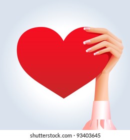 Woman's hand holding deep red heart