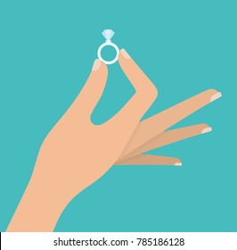 Woman's hand holding diamond ring
