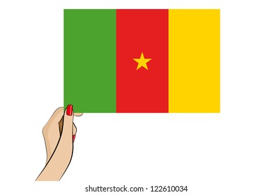 A womans hand holding the flag of Cameroon