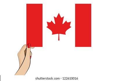 A womans hand holding the flag of Canada