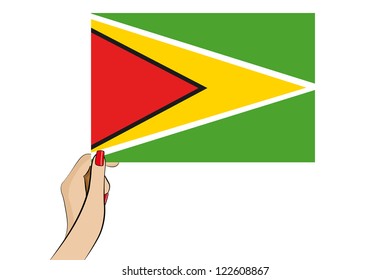 A womans hand holding the flag of Guyana