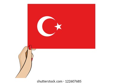 A womans hand holding the flag of Turkey