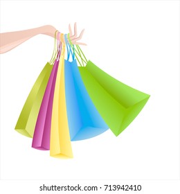 Woman's hand holding many colorful bags. Sale. Shopping