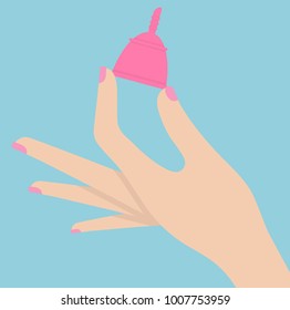 Woman's hand holding menstruation cup