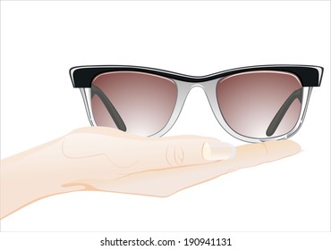 Woman's hand holding object- glasses isolated on white background.