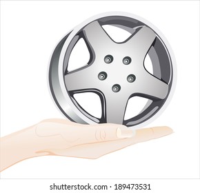 Woman's hand holding object-car wheel isolated on white background.