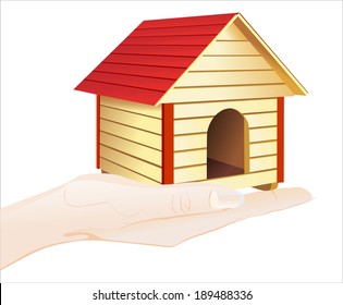 Woman's hand holding object-dog house