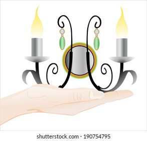 Woman's hand holding object-lamp isolated on white background.