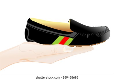 Woman's hand holding object-moccasin slipper