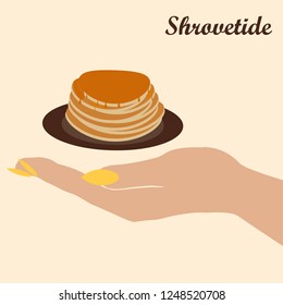 woman's hand holding pancakes on Maslenitsa