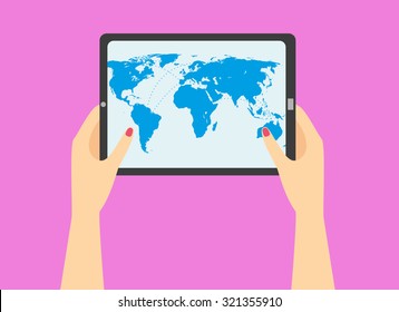 woman's hand holding a tablet with world map on the screen