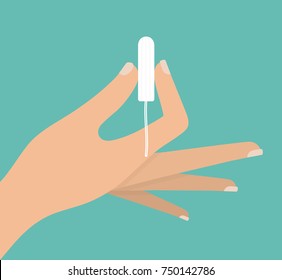 Woman's hand holding a tampon