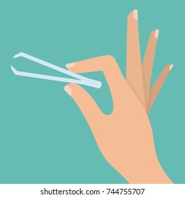 Woman's hand holding tweezers