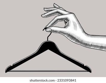 La mano de una mujer sostiene una percha en los dedos. Símbolo y metáfora de la tienda de ropa. Dibujo estilizado de grabado de época. Ilustración del vector