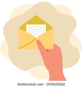 A woman's hand holds an open envelope with a letter