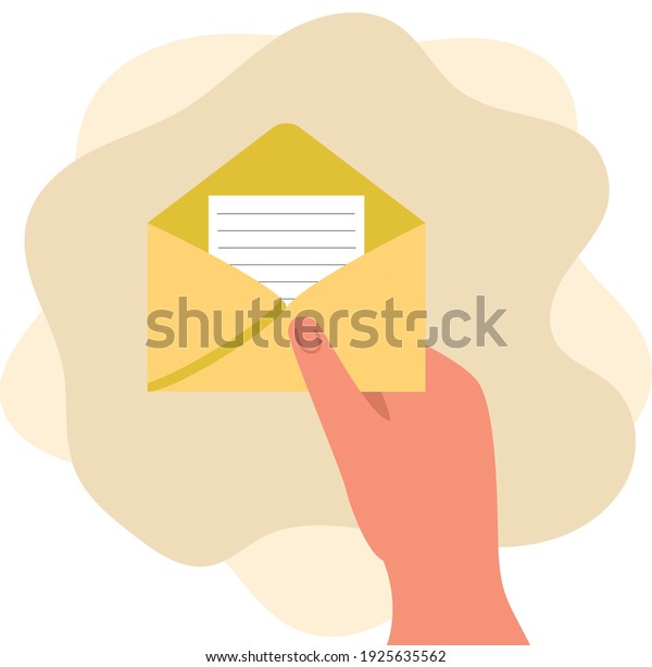 A\
woman\'s hand holds an open envelope with a\
letter