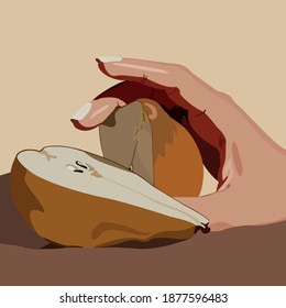 Woman's hand with a pear cut in half