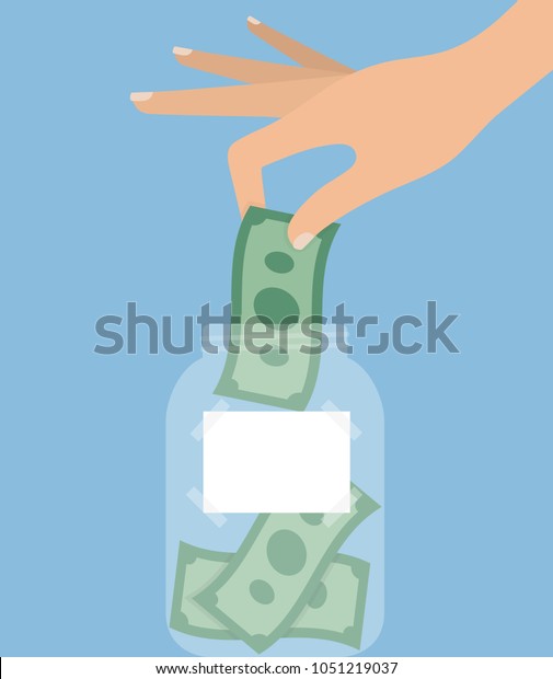Woman\'s hand putting money\
bill into a jar with a blank label on it. Savings and tipping\
concept