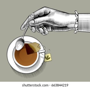 Woman's hand with a tea cup and spoon. Vintage stylized drawing. Vector illustration