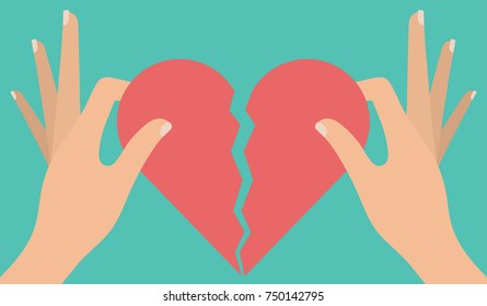 Woman's hand tearing apart a red heart