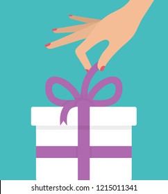 Woman's hand unboxing or unwrapping white gift box with purple ribbon