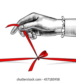 Woman's hand untying bow of red ribbon. Vintage engraving stylized drawing. Vector illustration