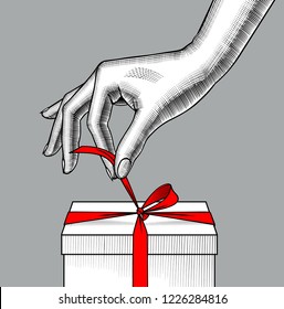 Woman's hand untying red ribbon bow of the gift box. Vintage engraving stylized drawing. Vector illustration