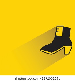 women boot with shadow on yellow background