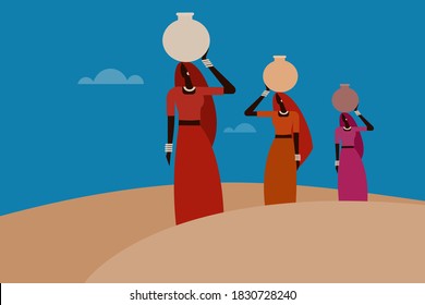 Women carrying water pots on their heads walk through the desert