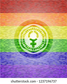 women cycle icon inside emblem on mosaic background with the colors of the LGBT flag
