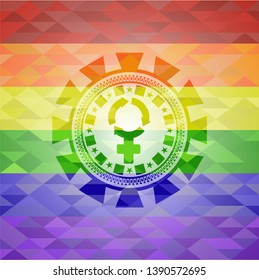 women cycle icon inside emblem on mosaic background with the colors of the LGBT flag