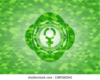 women cycle icon inside green emblem with mosaic background