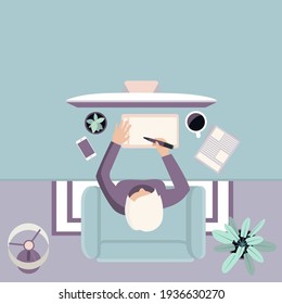 A women designer sitting at the table and working from home.
