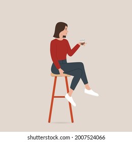 Women drinking coffee and sitting on bar stools