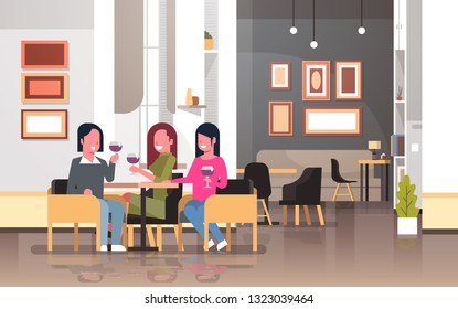 women drinking wine international happy 8 march day holiday concept girls sitting at cafe table modern restaurant interior ladies holding glasses horizontal flat