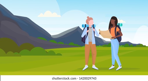 women hikers couple with backpack holding travel map mix race girls planning route hiking concept travelers on hike mountains landscape background full length horizontal flat