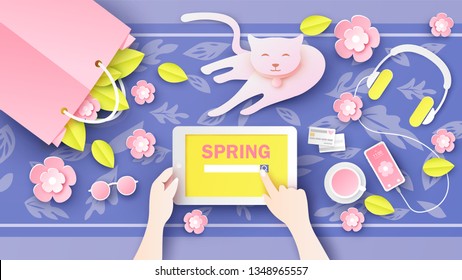 Women are internet searching for about Spring on tablet in hand and accessories pink set decorated with flower placed on the desk and cute cat pet. paper cut and craft style. vector, illustration.