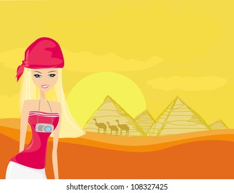  Women on background the pyramids in Giza built for the pharaoh.