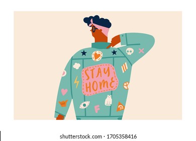 Women pointing to the embroidery sign on her jacket Stay home poster. Spreading information and awareness about coronavirus epidemic and self isolation.