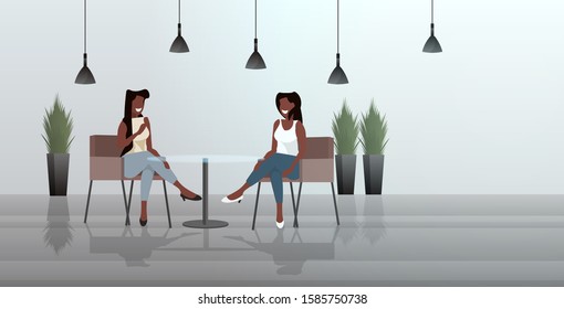 women sitting at cafe table african american girls couple discussing during meeting modern restaurant interior horizontal sketch full length vector illustration