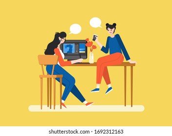 Women are sitting at a computer in a modern office and talk. Girl illustrator and manager. Effective and productive teamwork. Colorful vector illustration in flat cartoon style.