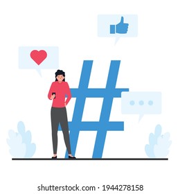 Women standing and holding phones next to a large hash tag.