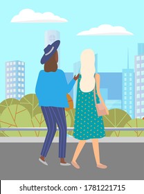 Women walking down the street. Meeting of girlfriends outdoor. Two friends women walking in city against the background of the cityscape of tall buildings. Female with bag and in hat summertime