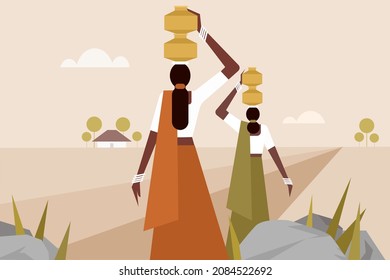 Women walking with water pots on their heads through a barren land