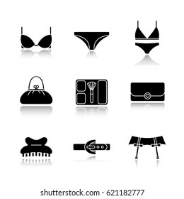 Women's accessories drop shadow black icons set. Underwear garters, bra and panties, clutch, purse, blusher, claw hair clip, leather belt. Isolated vector illustrations