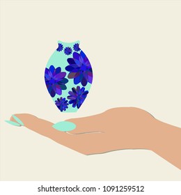 women's hand holding a blue vase