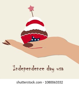 women's hand holding cupcake for us independence day