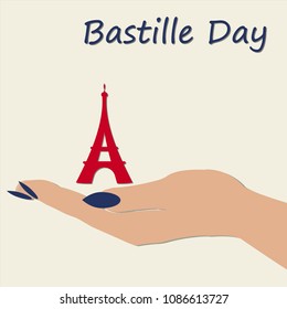 women's hand holding the Eiffel tower on Bastille day