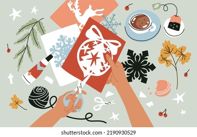 Decoración de las mujeres cortadas de manos para decorar el hogar. Proceso creativo. Hecho a mano, creando decoraciones navideñas, felicitaciones y tarjetas. Felices fiestas. Estilo plano en ilustración vectorial.